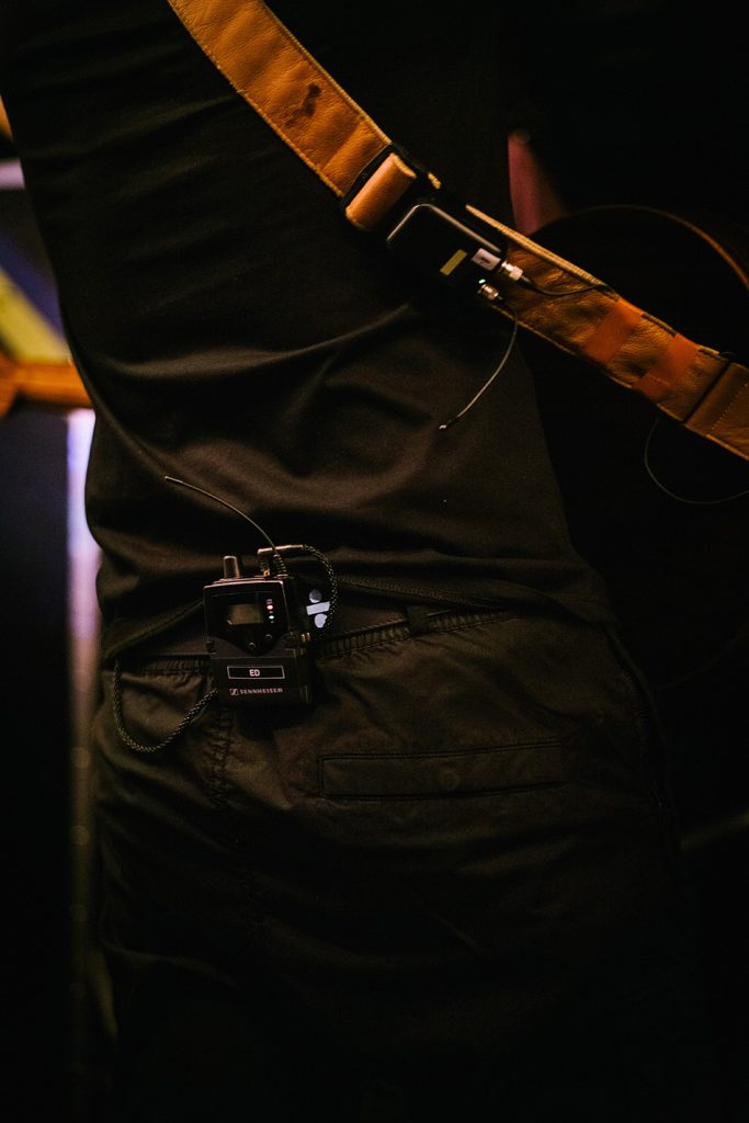 The SK 6212 mini-transmitter is attached to the guitar strap. ​ Photo credit: Zak Walters